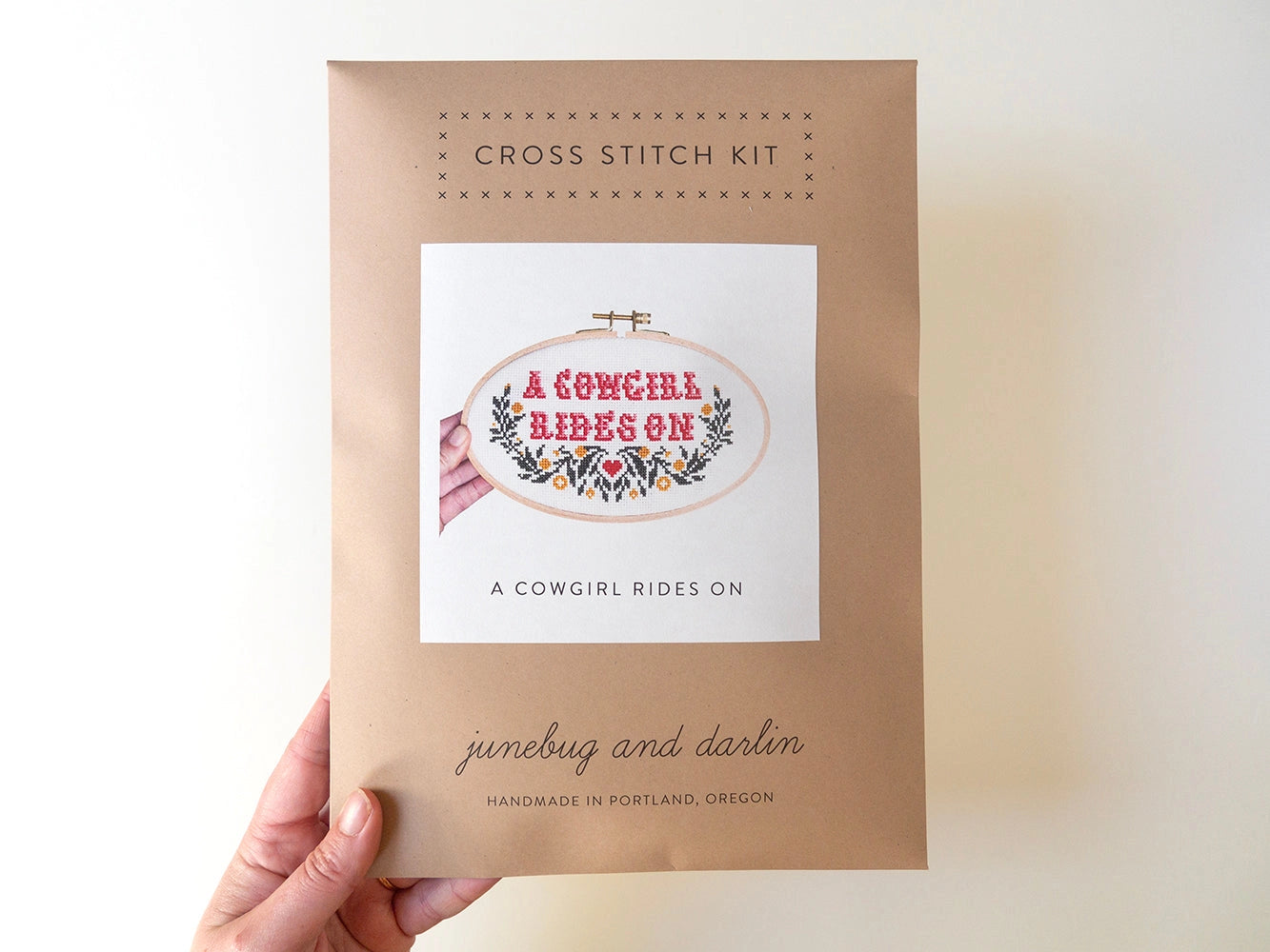 A cowgirl rides on cross stitch kit