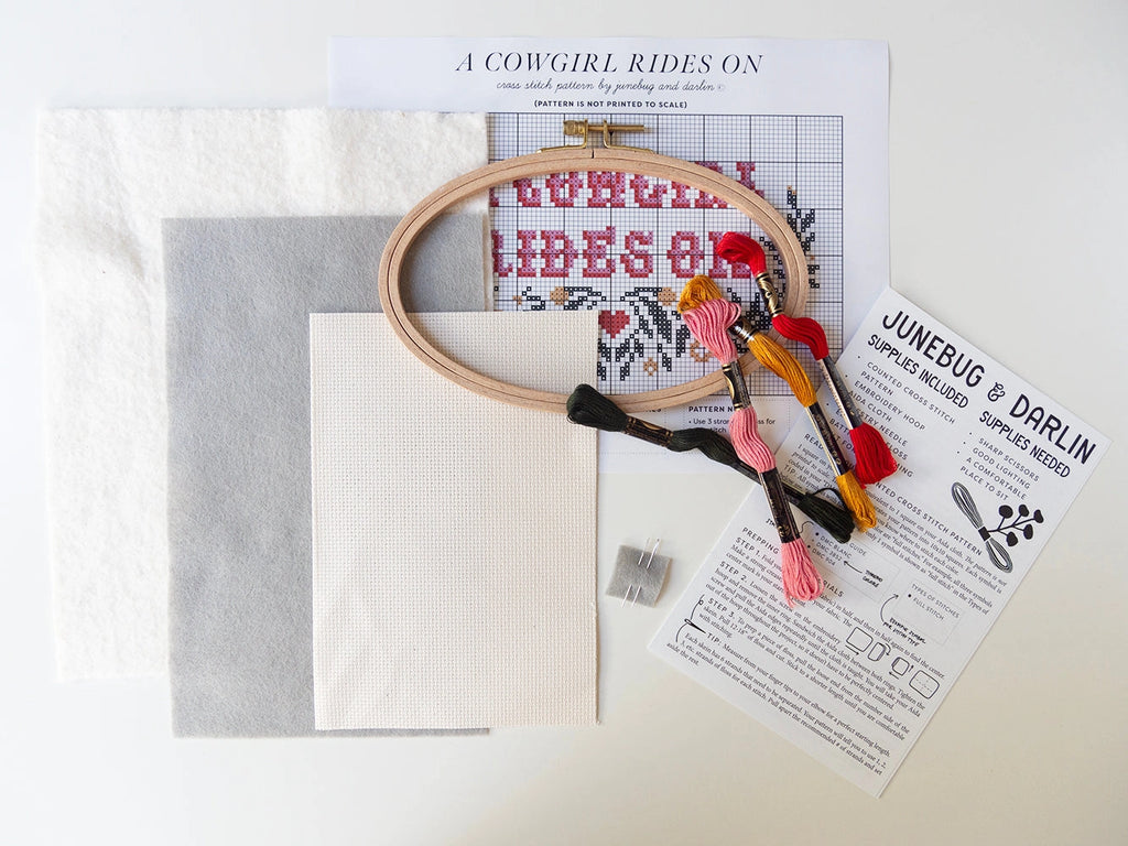 A cowgirl rides on cross stitch kit