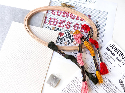 A cowgirl rides on cross stitch kit