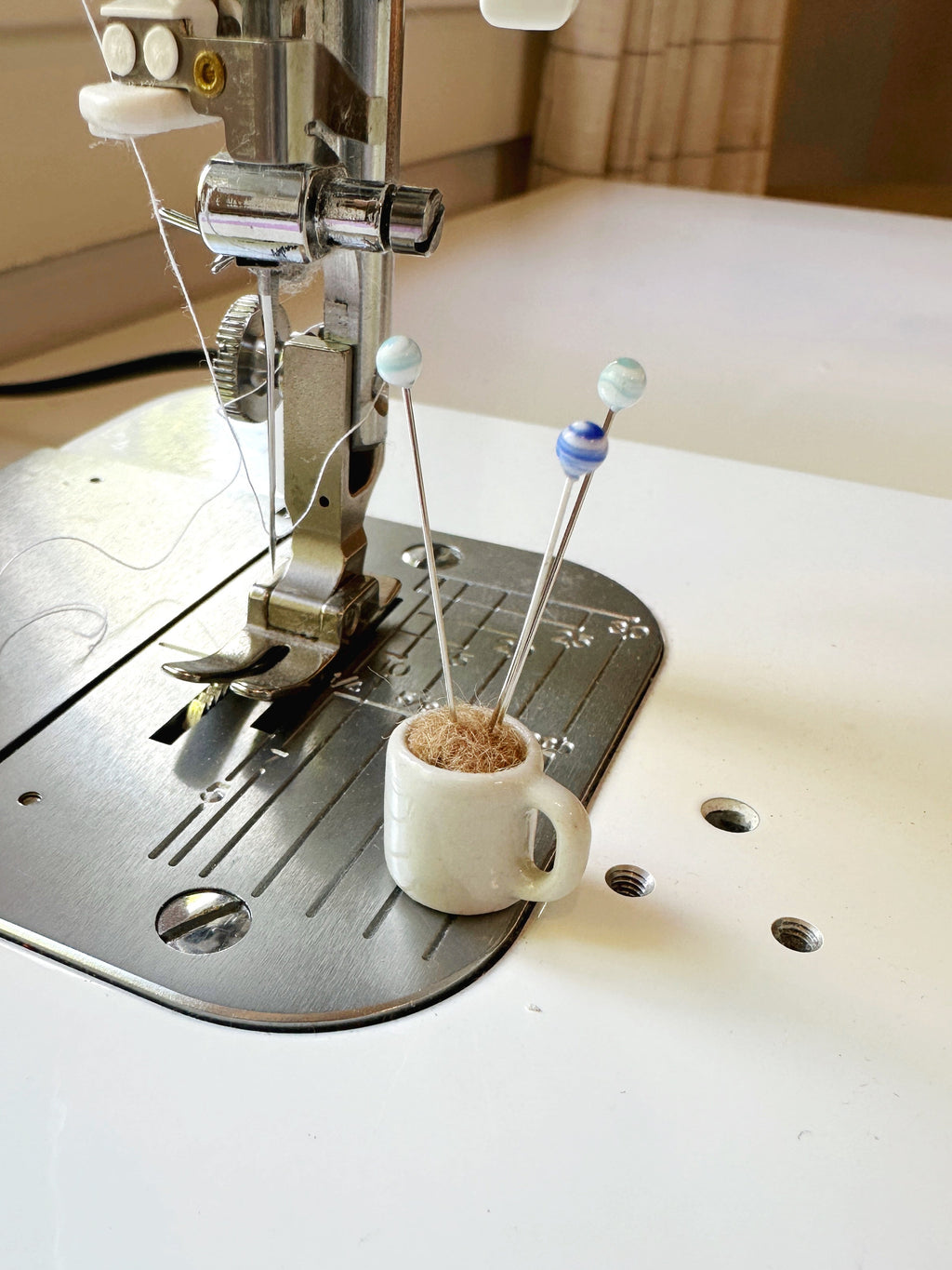 Coffee mug pin catcher