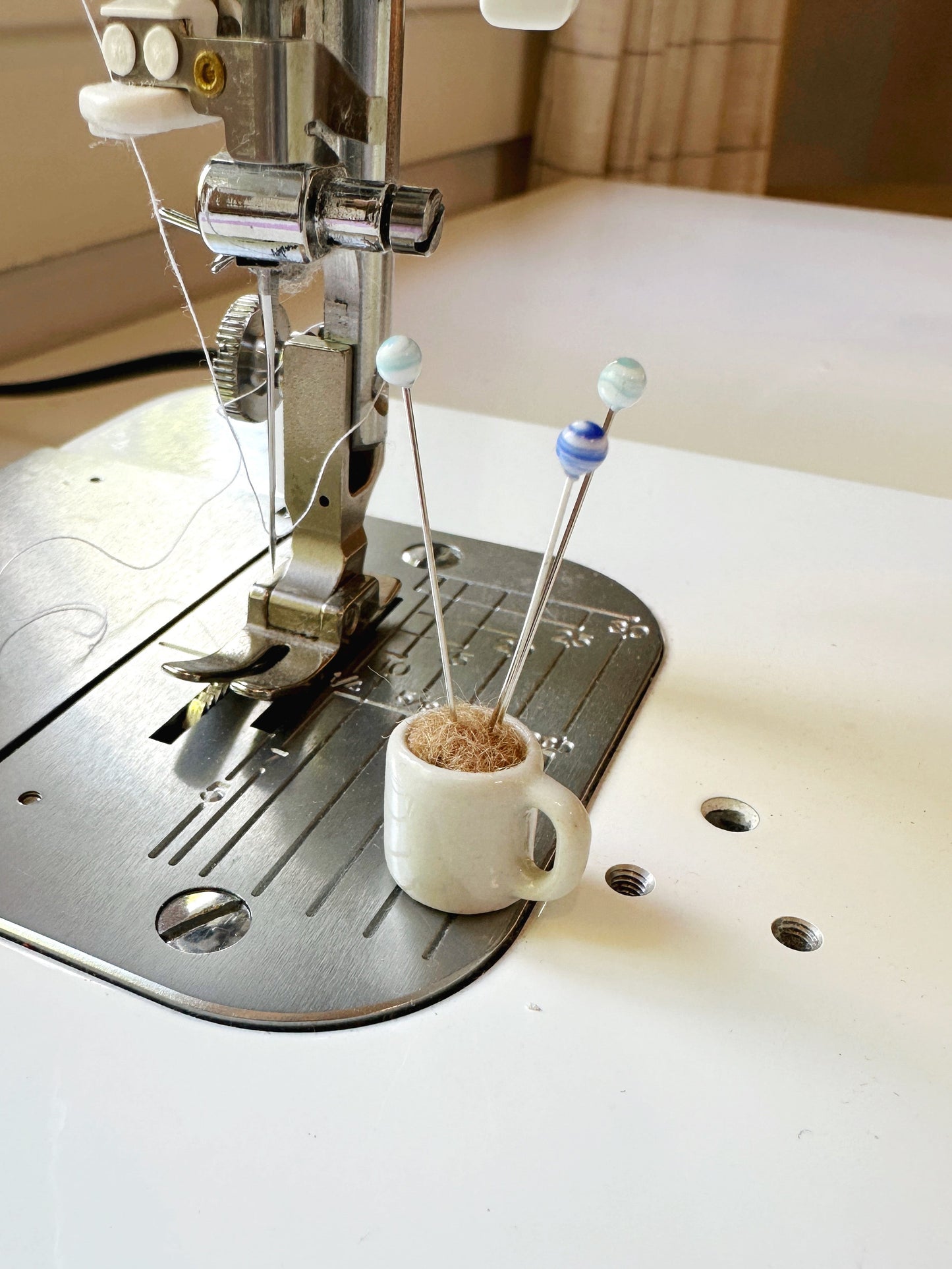 Coffee mug pin catcher