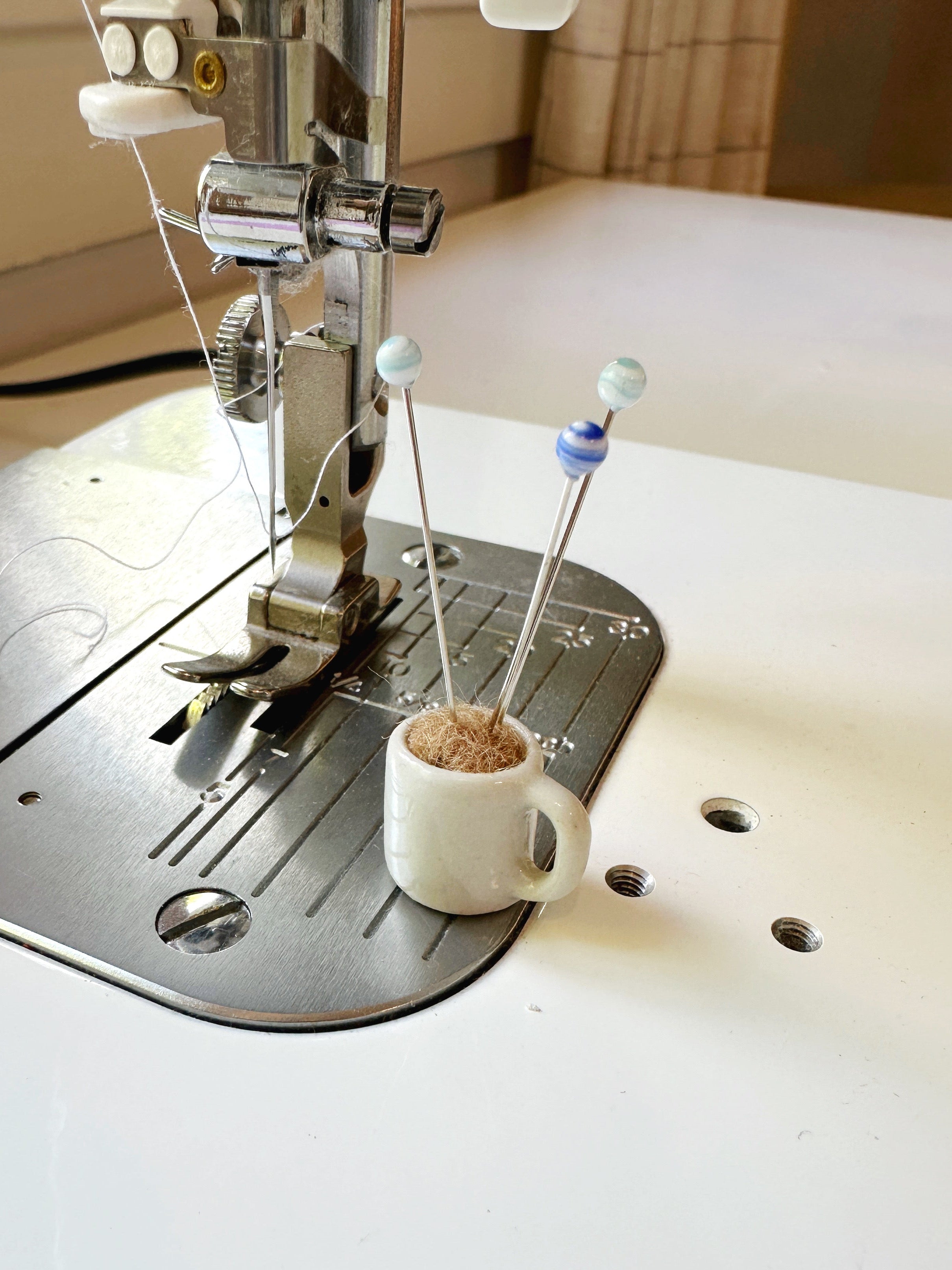 Coffee mug pin catcher