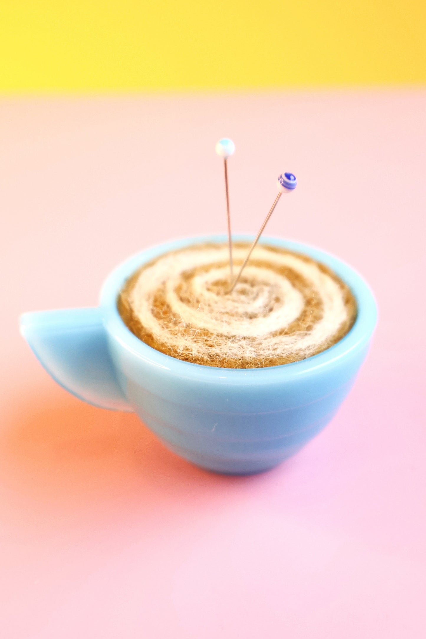 Blue glass and wool teacup pin cushion