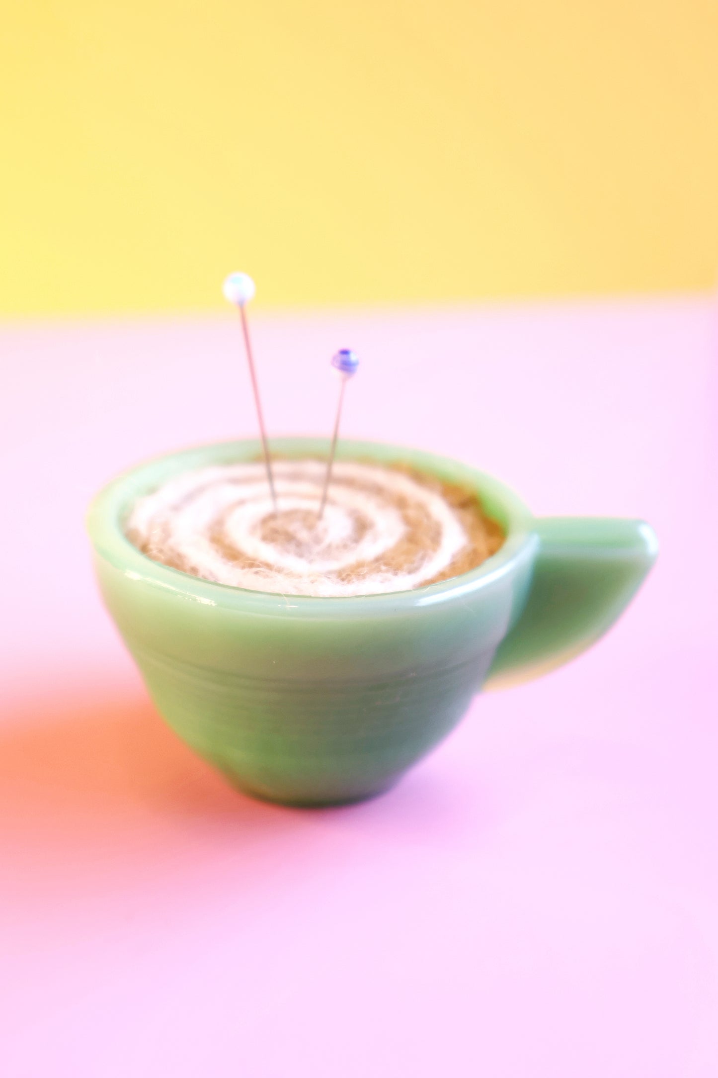Green glass and wool teacup pin cushion