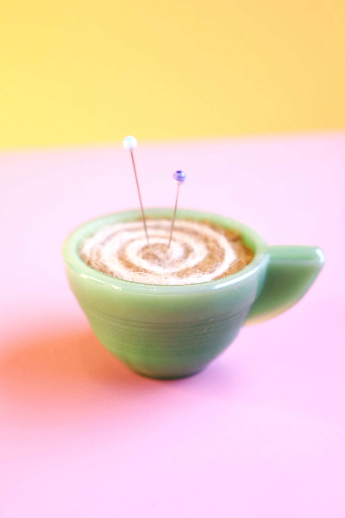 Green glass and wool teacup pin cushion