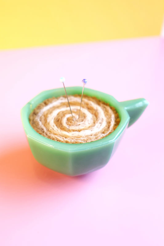 Green glass and wool teacup pin cushion