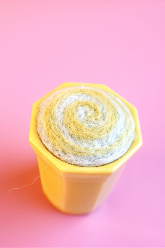 Yellow glass and wool pin cushion