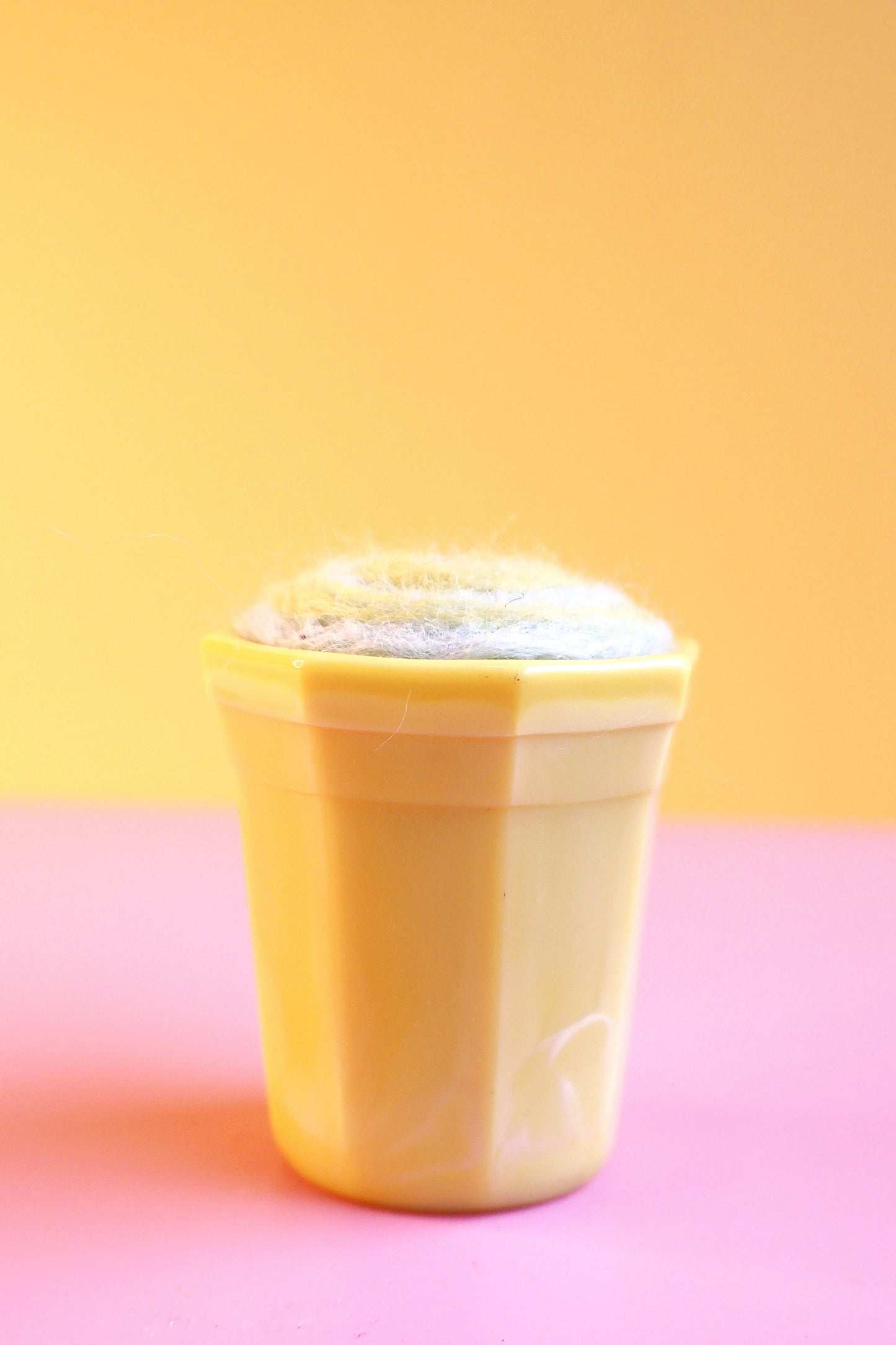 Yellow glass and wool pin cushion