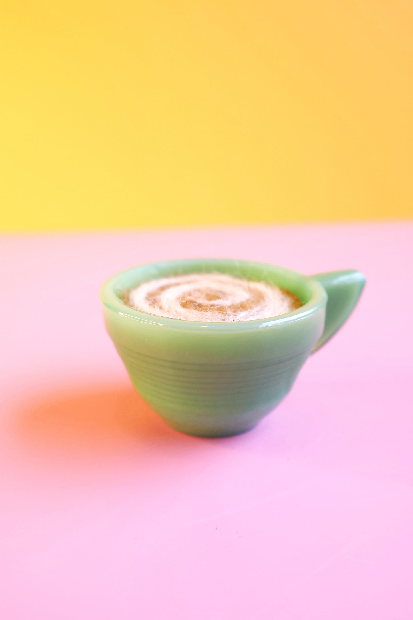 Green glass and wool teacup pin cushion