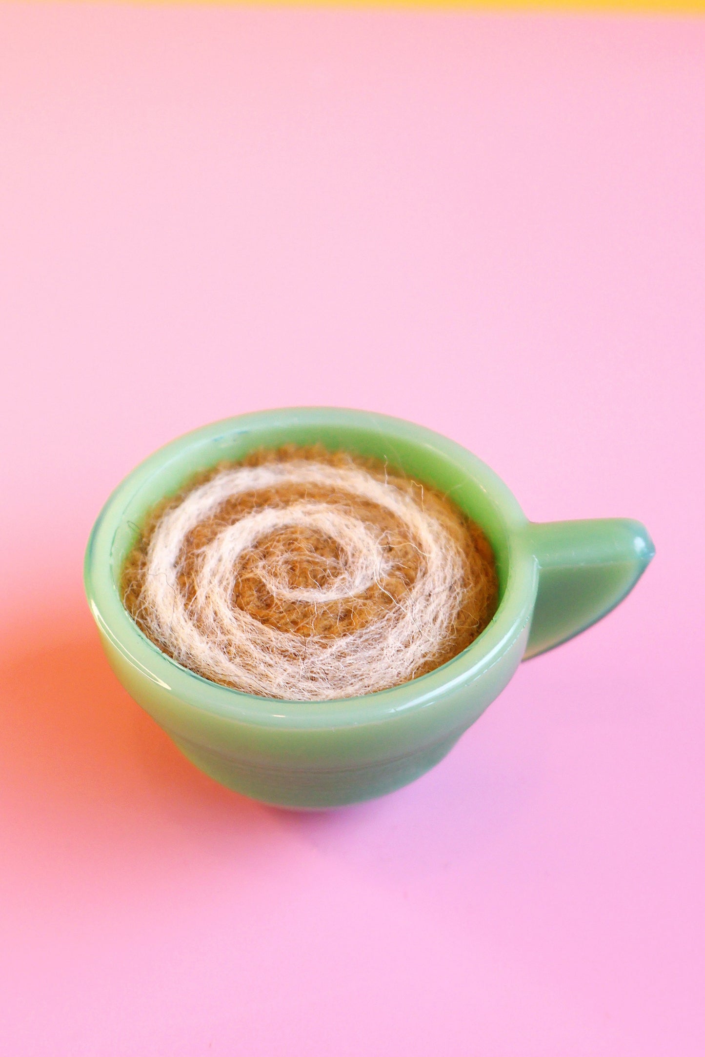 Green glass and wool teacup pin cushion