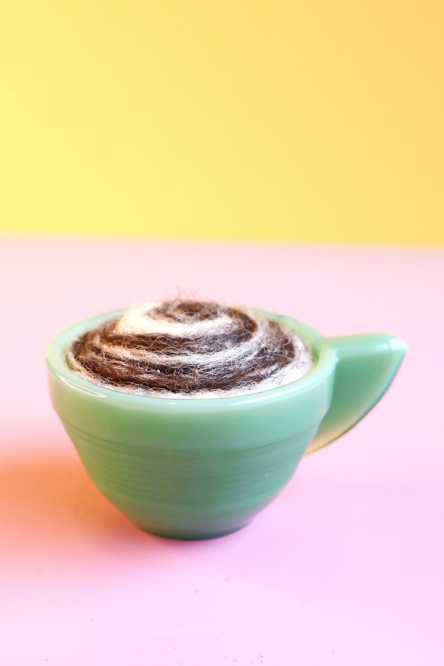 Green glass and wool teacup pin cushion