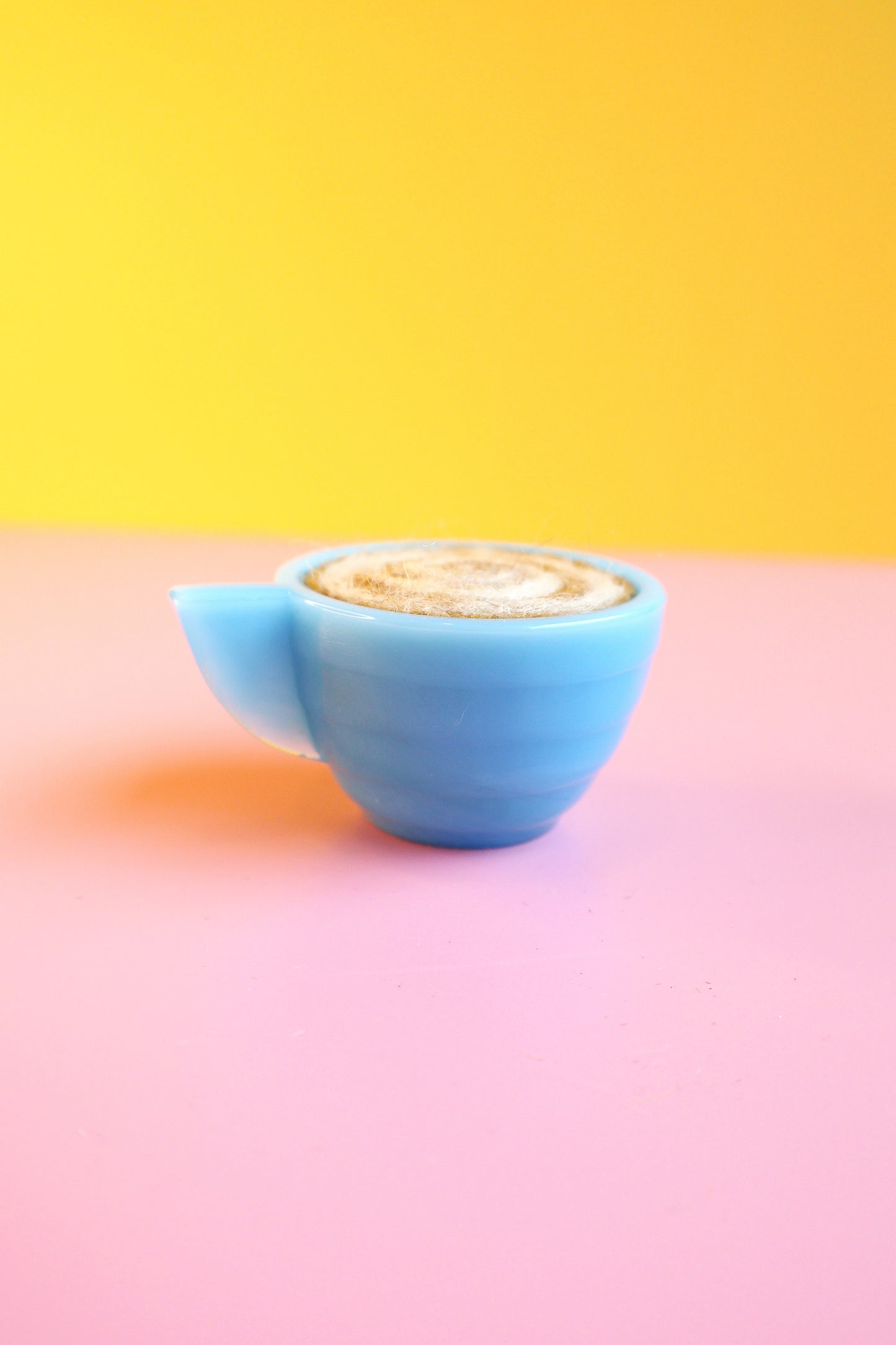 Blue glass and wool teacup pin cushion