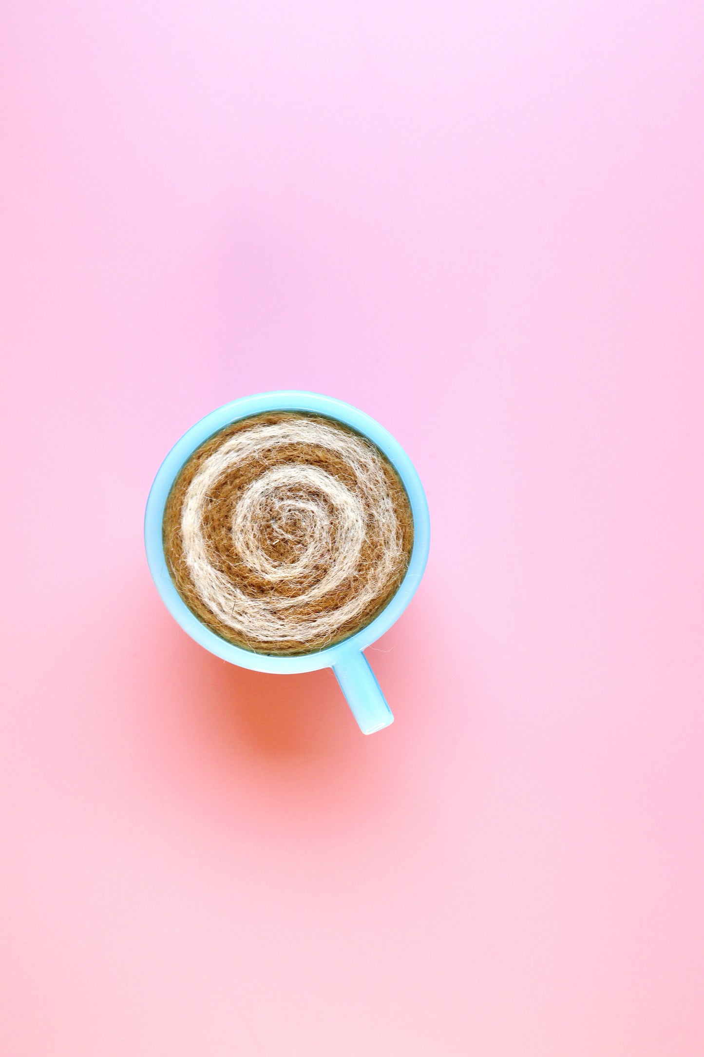 Blue glass and wool teacup pin cushion