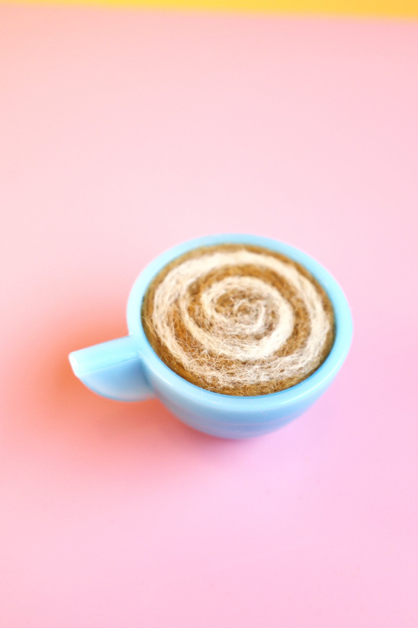 Blue glass and wool teacup pin cushion